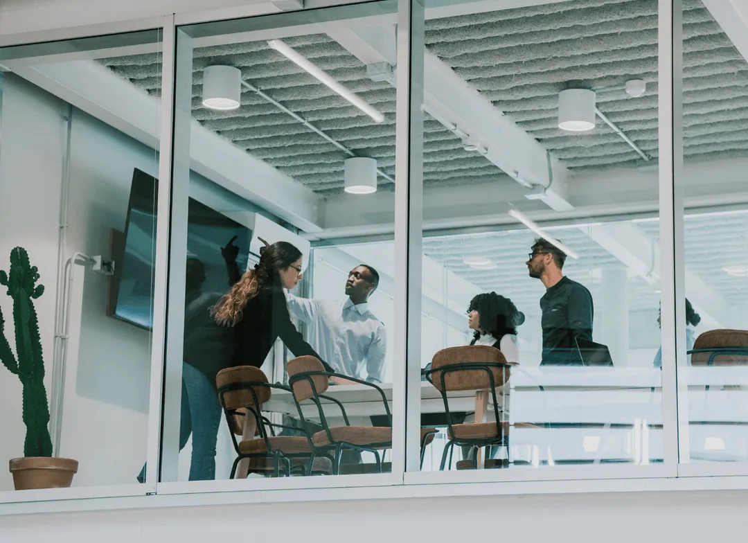 A team meeting in a glass-walled office