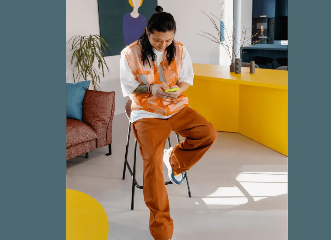 A person checking their phone in a bright studio