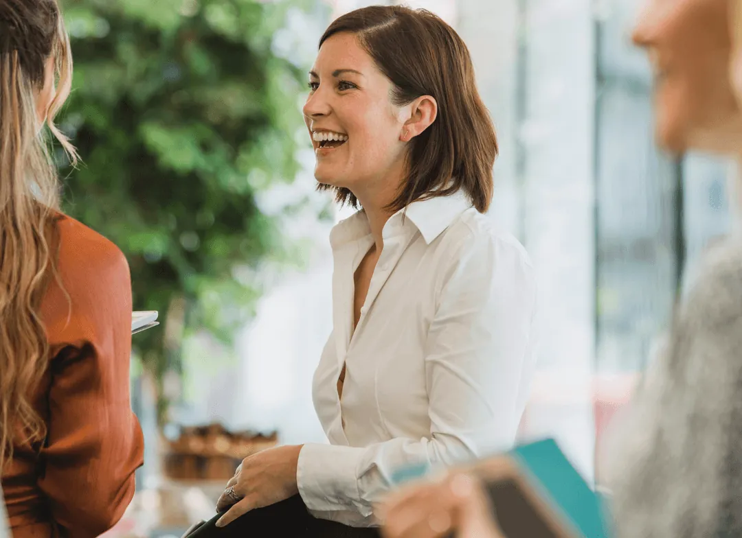 A smiling woman in a meeting