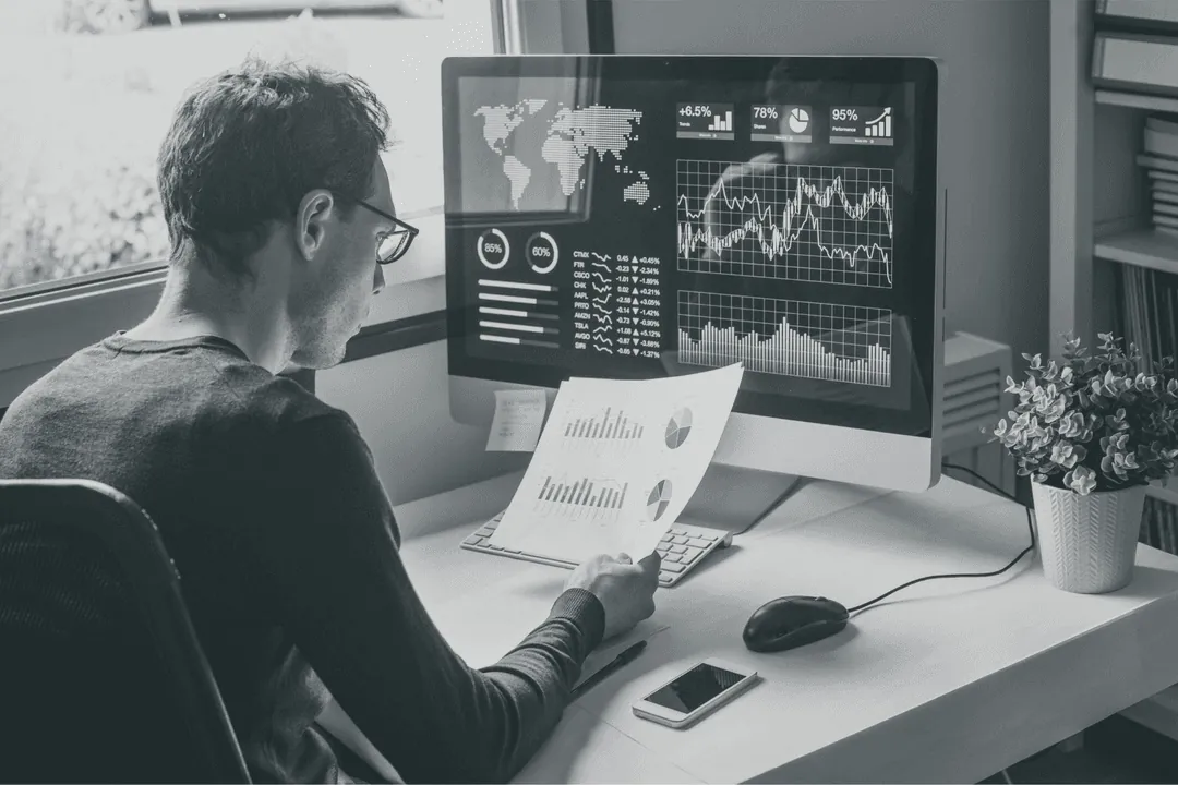 An analyst reviewing account data at a desk