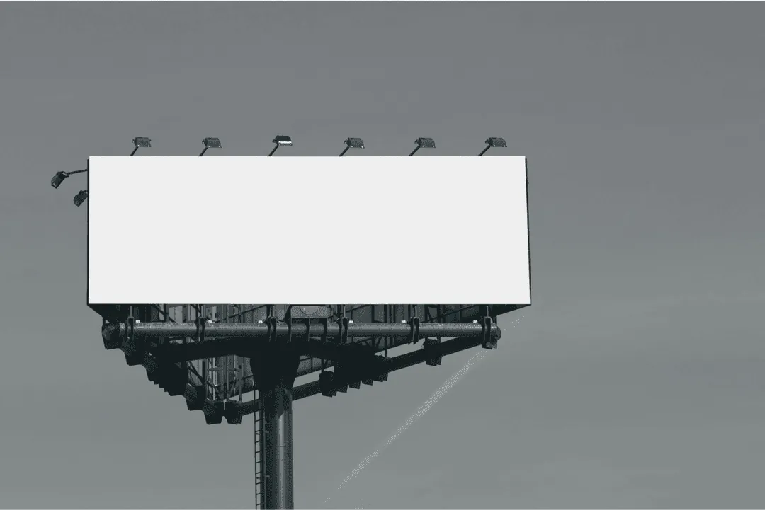 A blank billboard against a grey sky
